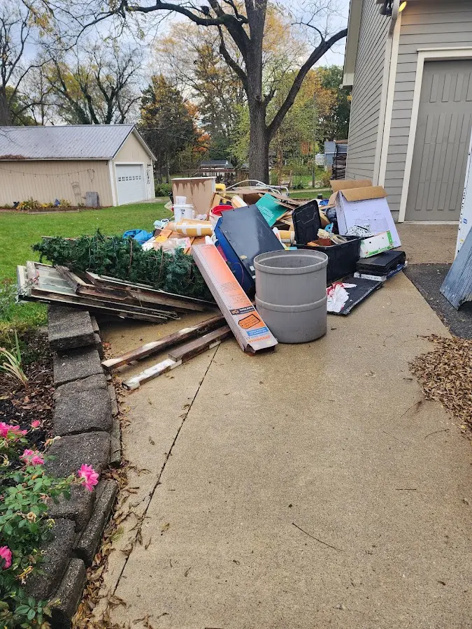 Dumpster being loaded with debris for Residential Dumpster Rental in Bellaire